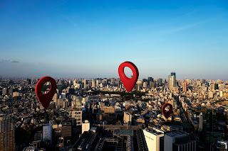 A cityscape with multiple red map pins.